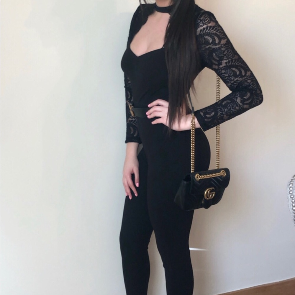 Black jumpsuit with lace sleeves.